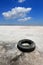 Abandoned tyre on salt sea shore