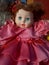 Abandoned unnecessary doll in a beautiful pink dress