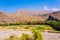 Abandoned village ruins of Riwaygh as-Safil with an oasis underneath on the road between Al Hambra and Jebel Shams