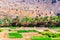 Abandoned village ruins of Riwaygh as-Safil with an oasis underneath on the road between Al Hambra and Jebel Shams