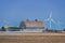 An abandoned vintage barn and wind turbines in Saskatchewan, Canada