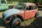 An abandoned Volkswagen Beetle in a junkyard in Cassiar, British