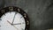 an abandoned wall clock with grey background .shows 3 o& x27;clock 5 minutes