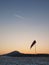 Abandoned winter airport wit windsock, evening blue sky with plane trail