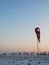 Abandoned winter airport wit windsock, evening blue sky with plane trail