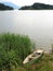 Abandoned wooden boat at shore of lake in mountainous region