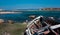 abandoned wooden fish boat at the shore. The boat is destroyed and rusty an completely useless with the sea and the blue sky at