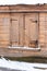 Abandoned wooden house with closed window in winter day, Talsi, Latvia