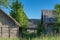 An abandoned wooden house in the countryside, grey wooden farm buildings