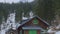 Abandoned wooden house in forest at bottom of mountains, avalanche danger