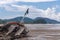 Abandoned wrecked fishing boat by the sea on a cloudy day. Scenic sea-side view.