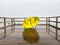 Abandoned Yellow Umbrella on Misty Pier