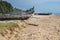 Abandonned artistic wooden canoe on a lonely beach