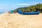 Abandonned artistic wooden canoe on a lonely beach