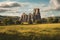 The abbey ruin of Glastonbury on a low hill in a windswept green landscape with a distant forest and far distant mountains.