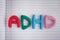 Abbreviation ADHD made out of plasticine on notebook sheet