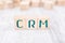 The Abbreviation CRM Formed By Wooden Blocks On A White Table