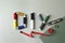 Abbreviation DIY made of spools of colorful threads and sewing supplies on color background, flat lay