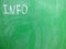 Abbreviation INFO written on a green, relatively dirty chalkboard by chalk. Located in the upper left corner of the image making