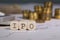 Abbreviation IPO composed of wooden letter. Stacks of coins in the background