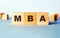 The abbreviation MBA is written on wooden cubes