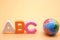 ABC first letter of the English alphabet and a small globe. Empty space for text. English for beginners