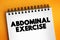 Abdominal exercise - type of strength exercise that affect the abdominal muscles, text on notepad