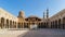 Ablution fountain mediating courtyard of mosque of Sultan al Muayyad, arched corridors, dome and minarets, Cairo, Egypt