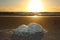 Abnormal foam on the beach. pollution of the sea, poisonous discharges. salt foam, agglomerated on the sand of a beach at sunset