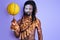 aborigen black man in national authentic wear holding yellow ball in hands