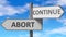 Abort and continue as a choice - pictured as words Abort, continue on road signs to show that when a person makes decision he can