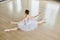 Above angle of back of graceful ballerina outstretching her arms and legs