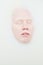 Above angle of face of young albino woman with closed eyes