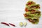 From above corn tortillas with redish, cucumber, onion, parsley, pepper and lettuce on white wooden background. Copy space. Top