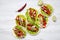 From above corn tortillas with redish, cucumber, onion, parsley, pepper and lettuce on white wooden background. Top view.