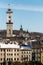 Above the European houses in the old part of Lviv rises Town Hall Lviv tower and Dormition Church in winter day