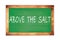 ABOVE  THE  SALT text written on green school board