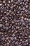 From above shot of coffee beans on table. Vertical close up shot.