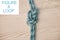 Above shot of hiking rope tied in a knot against a wooden background in studio. Figure 8 knot, A knot for every