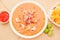 Above view of Ecuadorian food: shrimp cebiche with some chifles inside white bowl, lemon and red spicy salad inside a