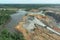 Above View Excavator and dump truck working in coal mine area.