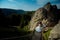 Above view of the glamour bride going down the wooden stairs to the blond groom. Mountains location. Beautiful nature