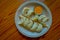 Above view of steamed Momo served in a white plate. A popular Nepalese food that is also common in Chiana, Bhutan, Tibet