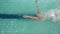 Above view of swimmer diving into pool