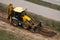 Above view of tractor doing earthwork in spring