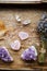 Above view of two polished pink color rose quartz crystals on wood tray in home. Attract love, healing heart chakra concept.