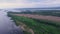 above wide river with islands in summer, aerial shot