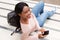 Above of young african american woman smiling with mobile phone