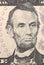 Abraham Lincoln face on US five or 5 dollars bill macro, united states money closeup.
