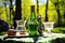 absinthe glassware and bottle on a sunny picnic day